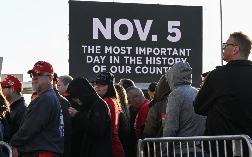 Supporters for former US President and Republican presidential candidate Donald Trump arrive for a campaign rally at the Suburban Collection Showplace in Novi, Michigan, 26 October, 2024.