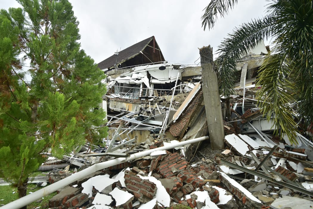 A general view shows a collapsed building in Mamuju