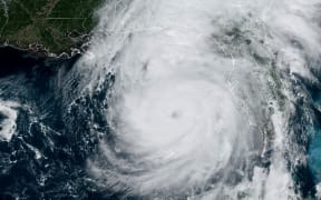 This image obtained from the National Oceanic and Atmospheric Administration (NOAA) shows Hurricane Helene on September 26, 2024, at 17:51 UTC. Parts of Florida face "unsurvivable" conditions when Hurricane Helene hits later Thursday, the US weather service said, warning that howling wind will drive destructive waves and storm surge as high as 20 feet (six meters) onto the low-lying coast. Residents heeded mass evacuation orders and fled ahead of the incoming hurricane -- projected to be one of the largest Gulf of Mexico storms in decades. (Photo by Handout / NOAA/GOES / AFP) / RESTRICTED TO EDITORIAL USE - MANDATORY CREDIT "AFP PHOTO / NOAA/GOES" - NO MARKETING NO ADVERTISING CAMPAIGNS - DISTRIBUTED AS A SERVICE TO CLIENTS