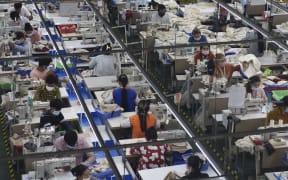 (211231) -- PHNOM PENH, Dec. 31, 2021 (Xinhua) -- Garment workers make clothes at a factory in Phnom Penh, Cambodia on Dec. 17, 2021.
  Officials and experts said Cambodia has pinned high hope on the Regional Comprehensive Economic Partnership (RCEP) and the Cambodia-China Free Trade Agreement (CCFTA) to boost its economic growth in the post-COVID-19 pandemic era.
The two free trade deals are due to enter into force on Jan. 1, 2022.
Enjoy Ho, deputy chairman of the Garment Manufacturers Association in Cambodia, said the two deals would bring about better development for Cambodia's textile and garment industry and added that with tariffs reduced or eliminated, cost for production would be cheaper. (Xinhua/Wu Changwei) (Photo by Wu Changwei / XINHUA / Xinhua via AFP)