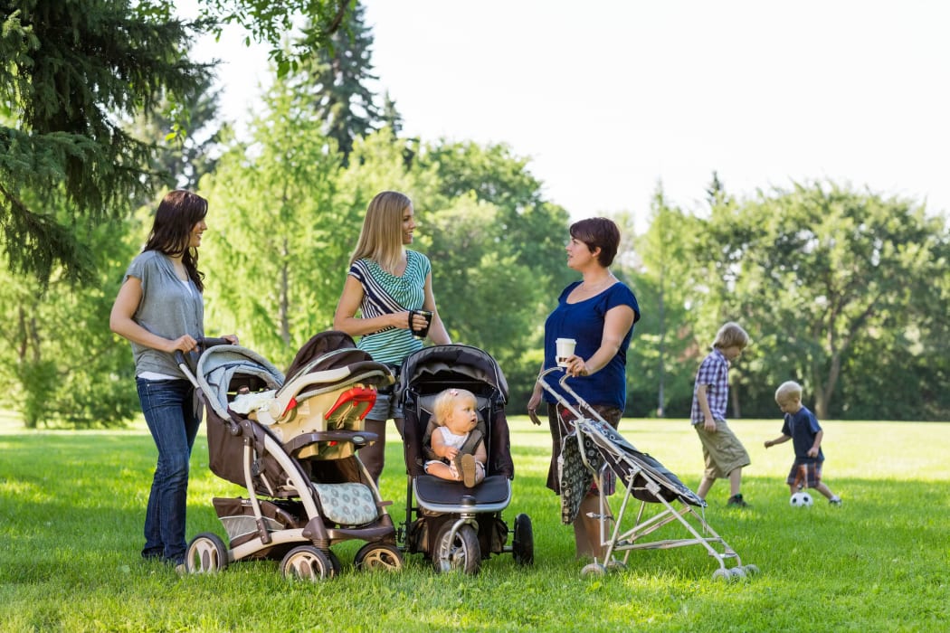 happy mothers with strollers