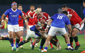 Tonga's Viliami Taulani is tackled during the first test against Samoa in Auckland.