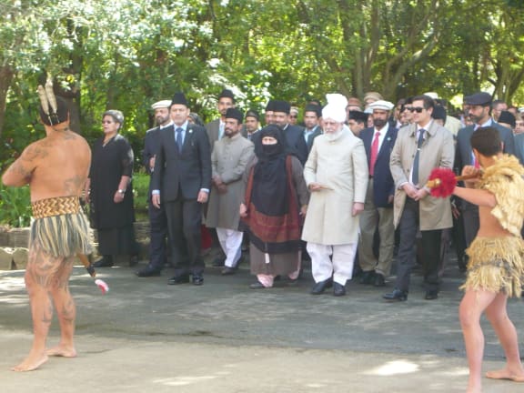 His Holiness Mirza Masroor Ahmad, wearing white, was welcomed onto the marae.