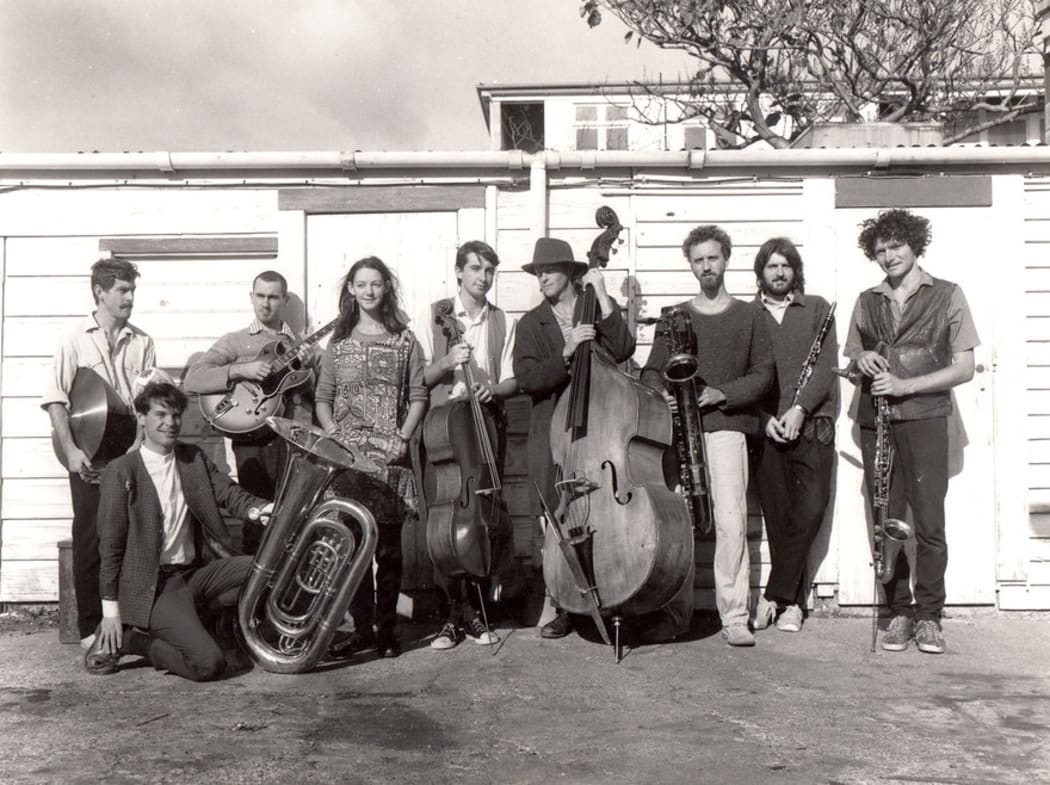The nine members of the Braille Collective circa 1985 with instruments
