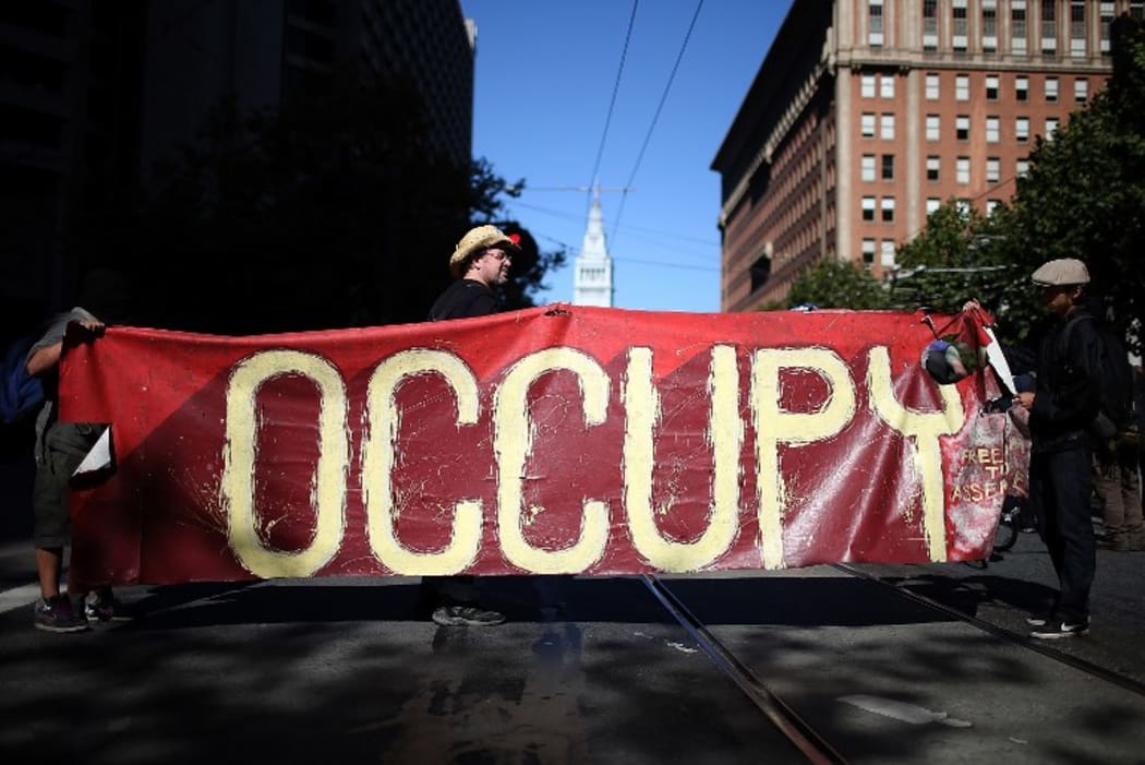 Occupy Wall Street protestors hold a large banner during a demonstration in San Francisco in 2012.