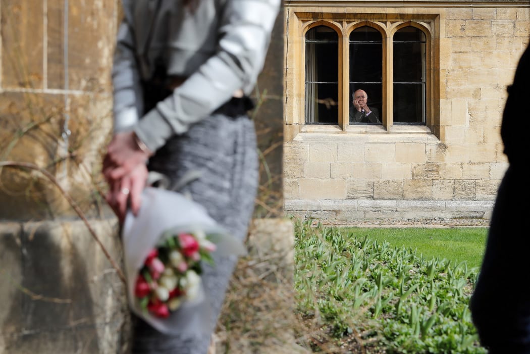 People queue to sign a book of condolence at Gonville and Caius College, Cambridge, where British physicist Stephen Hawking was a fellow for over 50 years.