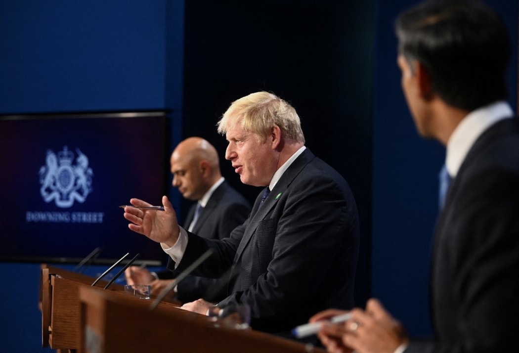 Britain's Prime Minister Boris Johnson (C), Britain's Health Secretary Sajid Javid (L) and Britain's Chancellor of the Exchequer Rishi Sunak attend a press conference inside the Downing Street Briefing Room in central London on September 7, 2021.
