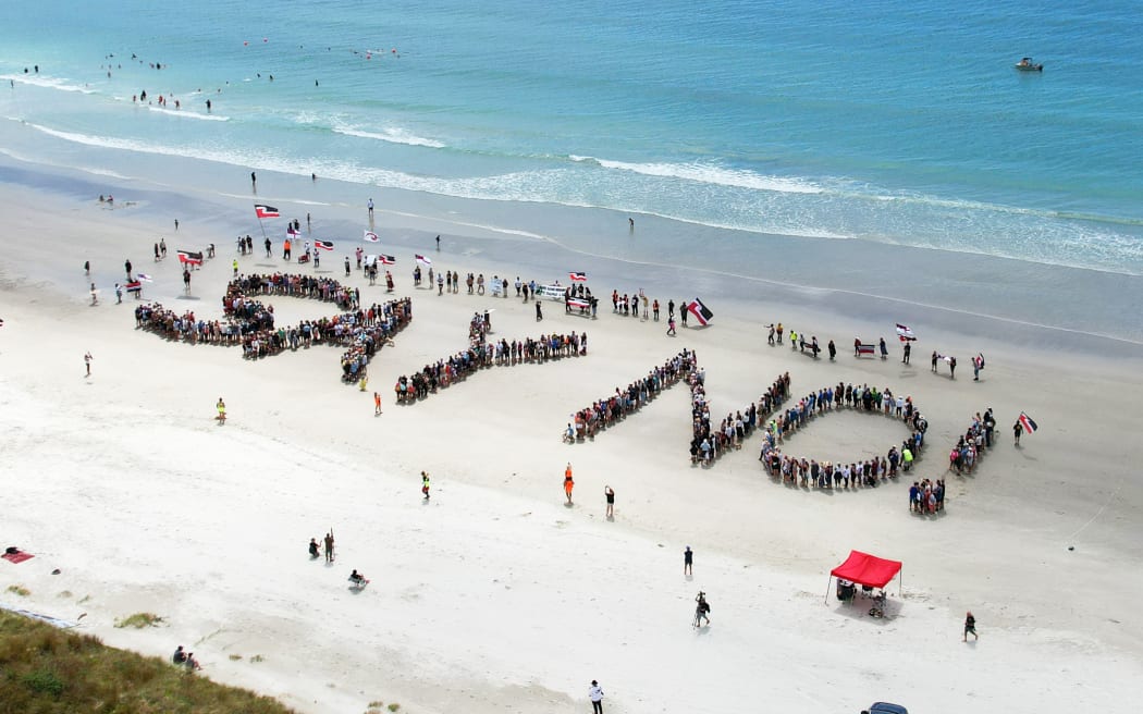 People spell out the words Say No! on Ruakaka Beach