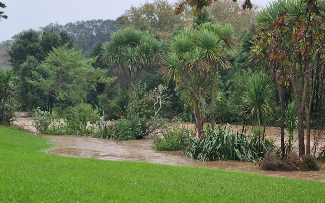 Swanson Stream in Henderson, Auckland running at a high level after heavy rain on 9 May 2023.