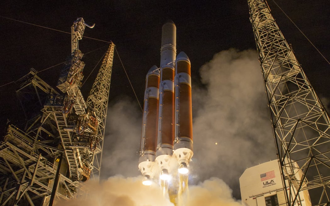 This handout photograph courtesy of NASA shows the United Launch Alliance Delta IV Heavy rocket launching NASA's Parker Solar Probe to touch the Sun, Sunday, August 12, 2018 from Launch Complex 37 at Cape Canaveral Air Force Station, Florida. NASA launched a $1.5 billion spacecraft toward the Sun on a historic mission to protect the Earth by unveiling the mysteries of dangerous solar storms.  The unmanned spacecraft's mission is to get closer than any human-made object ever to the center of our solar system, plunging into the Sun's atmosphere, known as the corona, during a seven-year mission.  he probe is guarded by an ultra-powerful heat shield that can endure unprecedented levels of heat, and radiation 500 times that experienced on Earth. (Photo by Bill INGALLS / NASA / AFP) / == RESTRICTED TO EDITORIAL USE / MANDATORY CREDIT:  "AFP PHOTO / NASA / BILL INGALLS " / NO MARKETING / NO ADVERTISING CAMPAIGNS / DISTRIBUTED AS A SERVICE TO CLIENTS ==