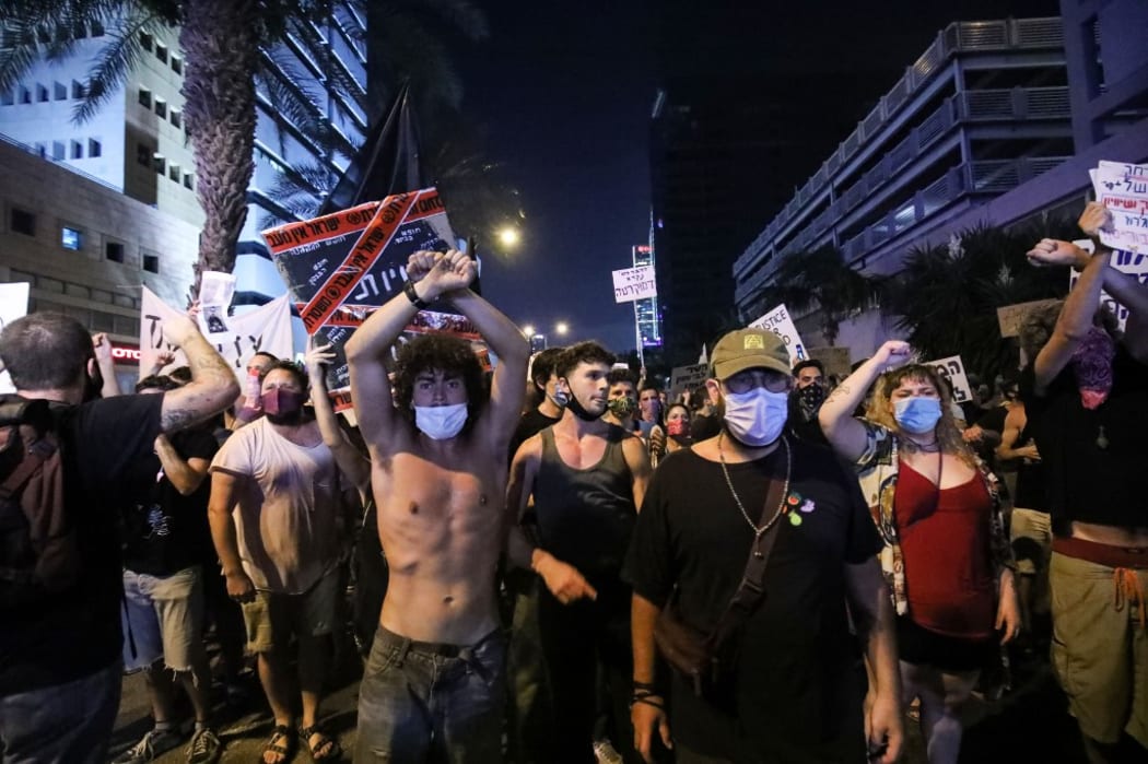 TEL AVIV, ISRAEL - JULY 29: People stage a protest against Israeli Prime Minister Benjamin Netanyahu, demanding his resignation over corruption cases and deterioration in economic conditions,