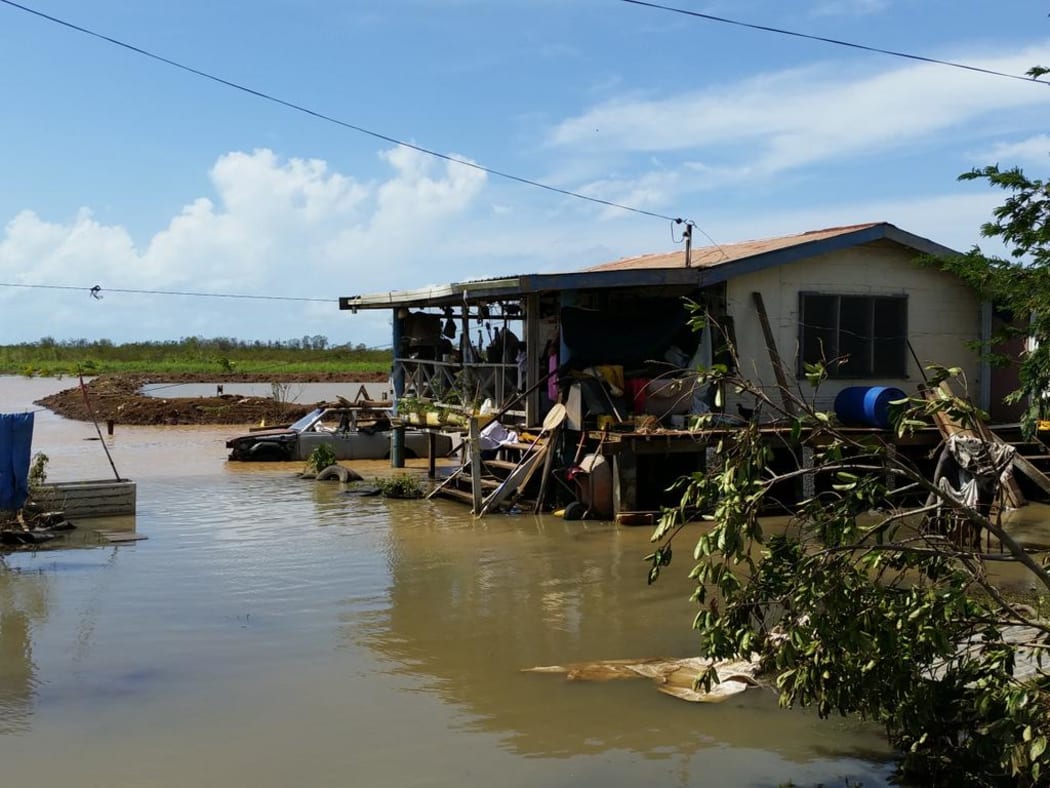 At a house in Lovu, near Lautoka, people wait for clean drinking water to arrive.