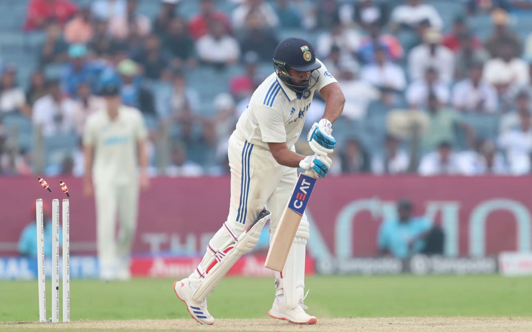 Rohit Sharma of India is bowled by Tim Southee of New Zealand during the 2nd Test in Pune, 2024.
