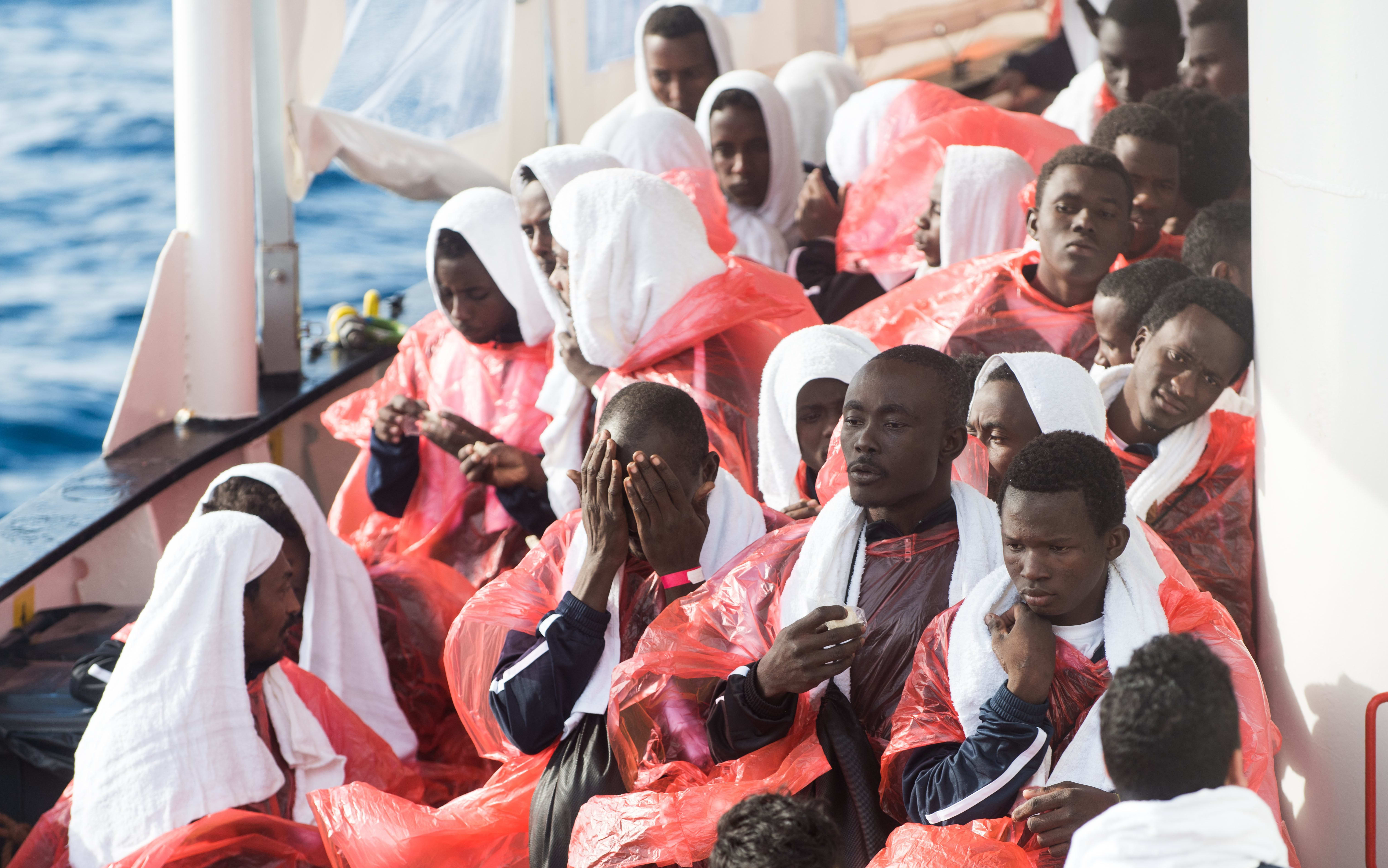 Migrants are rescued from a boat off the Libyan coast in December 2016. About 100 people are now missing after the boat they were on sank.