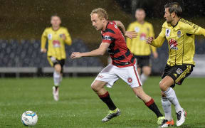 Mitch Nichols carries the ball while playing for the Western Sydney Wanderers against the Phoenix in 2016.