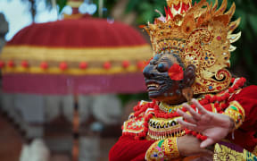 A person wearing traditional Balinese costume.