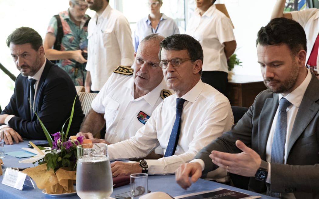 French Overseas Minister Manuel Valls (2nd-R) listens to French High Commissioner to New Caledonia Louis Lefranc (2nd-L) during a meeting with the nickel industry, elected representatives and trade unions at the High Commissioner's residence in Noumea on February 28, 2025. (Photo by Delphine MAYEUR / AFP)
