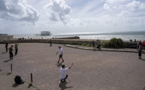 People play Petanque at the Brighton and Hove petanque club on the seafront on a late summer's day in Hove, on the south coast of England on August 31, 2025. (Photo by CARLOS JASSO / AFP)