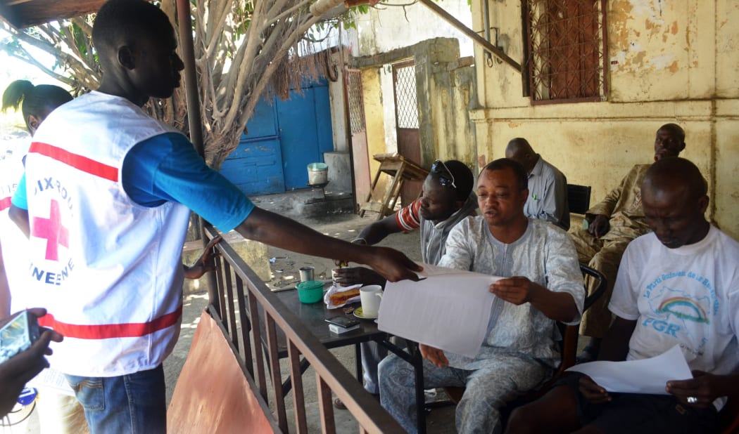 Guinean Red Cross staff distribute information on the Ebola virus.