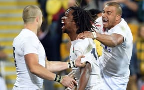 England's Marland Yarde (C) celebrates scoring against the Wallabies with team-mates Mike Brown (L) and Jonathan Joseph (R) in their international rugby union match played in Brisbane on June 11, 2016. 
WILLIAM WEST / AFP