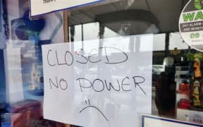 Signs in front of a laundromat, the Kerikeri Library and Unichem Pharmacy to say they are closed as there is no power on 20 June 2024 in Kerikeri, Northland.