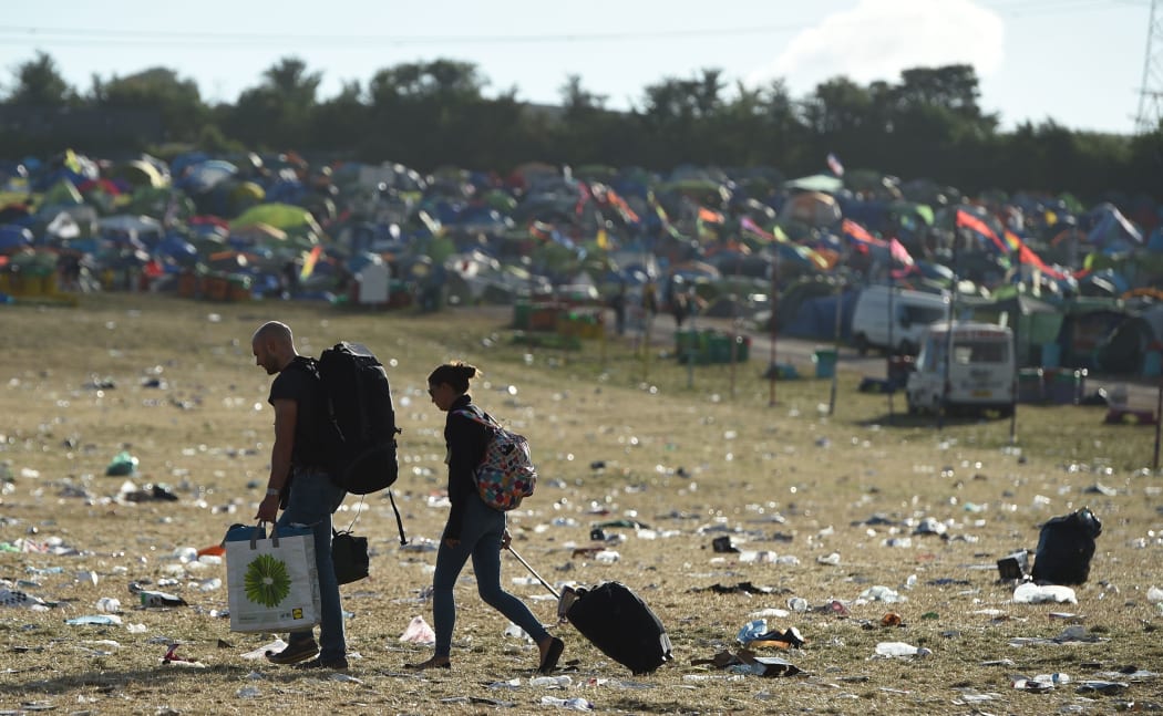 Revellers depart Glastonbury Festival of Music and Performing Arts on Worthy Farm near the village of Pilton in Somerset, South West England, on July 1, 2019.