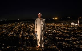A Syrian Kurdish refugee waits after crossing the border into Turkey.