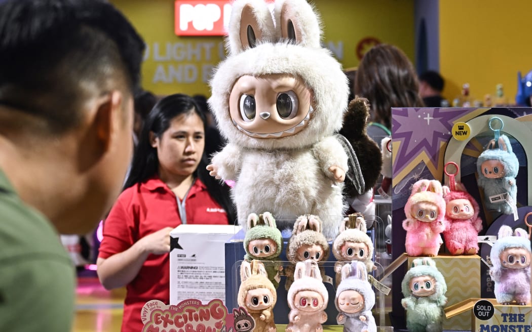 People look at collectible designer art toy Labubu at a Pop Mart pop-up store in Siam Center shopping mall in Bangkok on 6 May 2025. (Photo by Lillian SUWANRUMPHA / AFP)