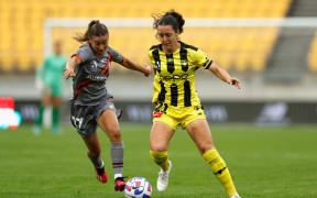 Michaela Foster of the Phoenix and Indiah-Paige Riley of Brisbane Roar.