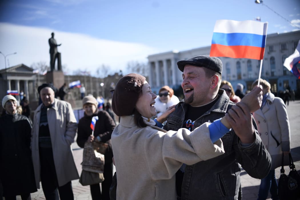 A man holds a Crimean flag outside the Crimean parliament building in central Simferopol.