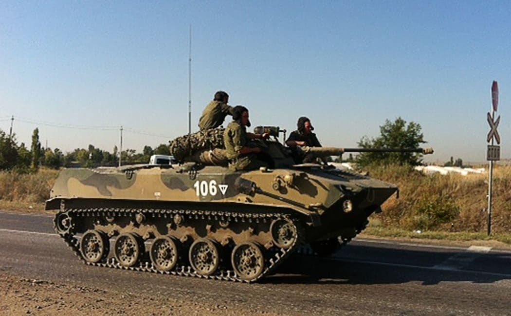 A Russian military vehicle moves along a road near the Ukrainian border on 15 August.