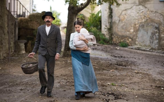 (Preval) Jacques Gambin and his wife Philomène (Laetitia Casta) in The Ideal Palace.