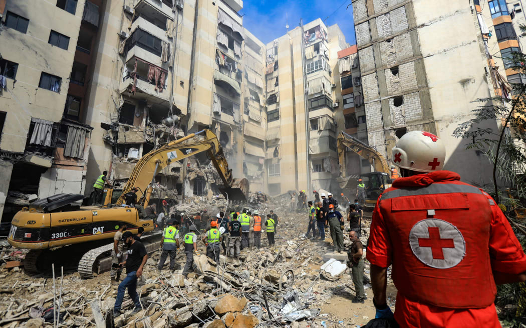 Rescuers sift through the rubble at the scene of an Israeli strike that targeted Beirut's southern suburbs a day earlier, as search and rescue operations continue on September 21, 2024. Lebanon's Hezbollah said on September 21 that a second senior commander was among 16 fighters killed in an Israeli air strike on its Beirut stronghold the previous day, highlighting the scale of the blow to its military leadership. (Photo by AFP)