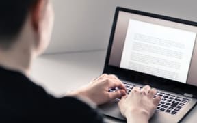 A man uses a laptop computer.
