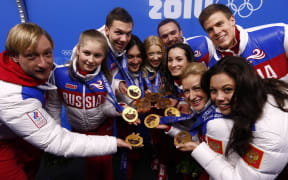 Russian athletes show off their gold medals at the 2014 Sochi Olympics.