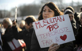 A woman pays tribute to those killed in the attack on the offices of Charlie Hebdo.