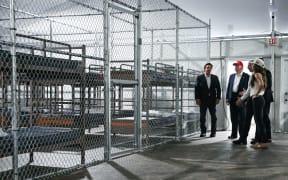 US President President Donald Trump (2L), Florida Governor Ron DeSantis (L), and Secretary of Homeland Security Kristi Noem (R) tour a migrant detention center, dubbed "Alligator Alcatraz," located at the site of the Dade-Collier Training and Transition Airport in Ochopee, Florida on July 1, 2025. President Trump is visiting a migrant detention center in a reptile-infested Florida swamp dubbed "Alligator Alcatraz." Trump will attend the opening of the 5,000-bed facility -- located at an abandoned airfield in the Everglades wetlands -- part of his expansion of deportations of undocumented migrants, his spokeswoman said. (Photo by ANDREW CABALLERO-REYNOLDS / AFP)