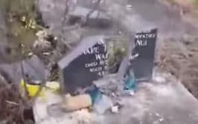 A smashed headstone at Raupunga Cemetery.