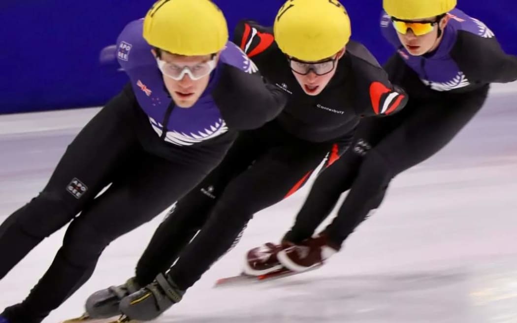Luke Street (centre) competing in short-track speed skating.