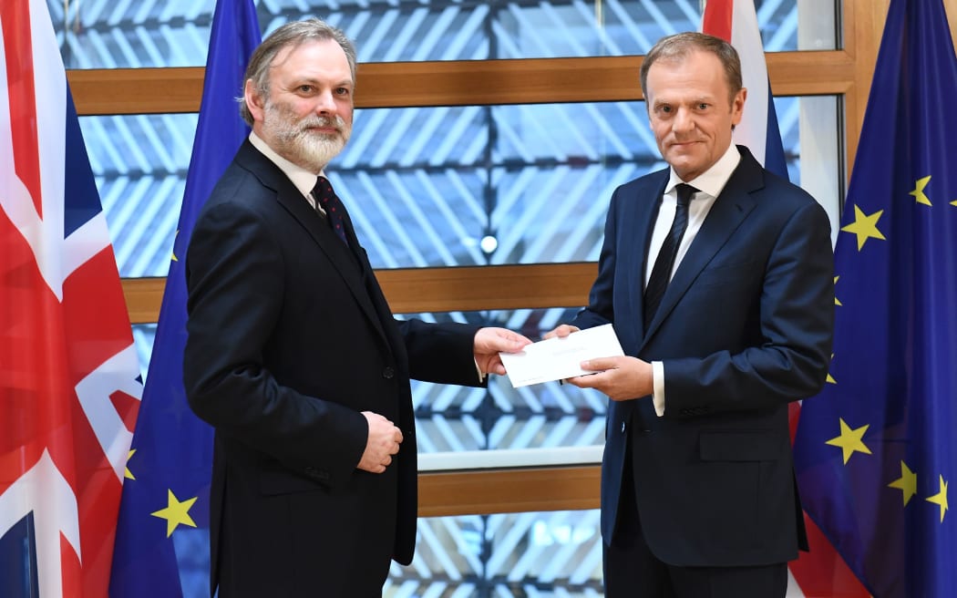 Britain's ambassador to the EU Tim Barrow delivers the formal notice of the UK's intention to leave the bloc to European Council President Donald Tusk in Brussels on March 29, 2017.
