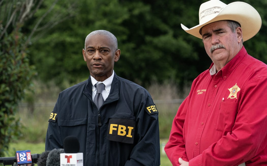 Special Agent in Charge of the FBI Houston James Smith and San Jacinto County Sheriff Greg Capers speak to media near the crime scene where five people, including an 8-year-old child, were killed after a shooting inside a home in Cleveland, Texas, on April 29, 2023.