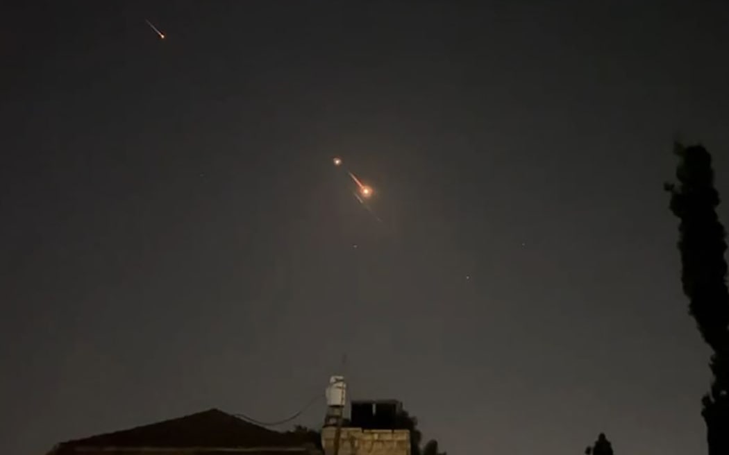This video grab from AFPTV taken on April 14, 2024 shows explosions lighting up Jerusalem sky during Iranian attack on Israel. Iran's Revolutionary Guards confirmed early April 14, 2024 that a drone and missile attack was under way against Israel in retaliation for a deadly April 1 drone strike on its Damascus consulate. (Photo by AFPTV / AFP)