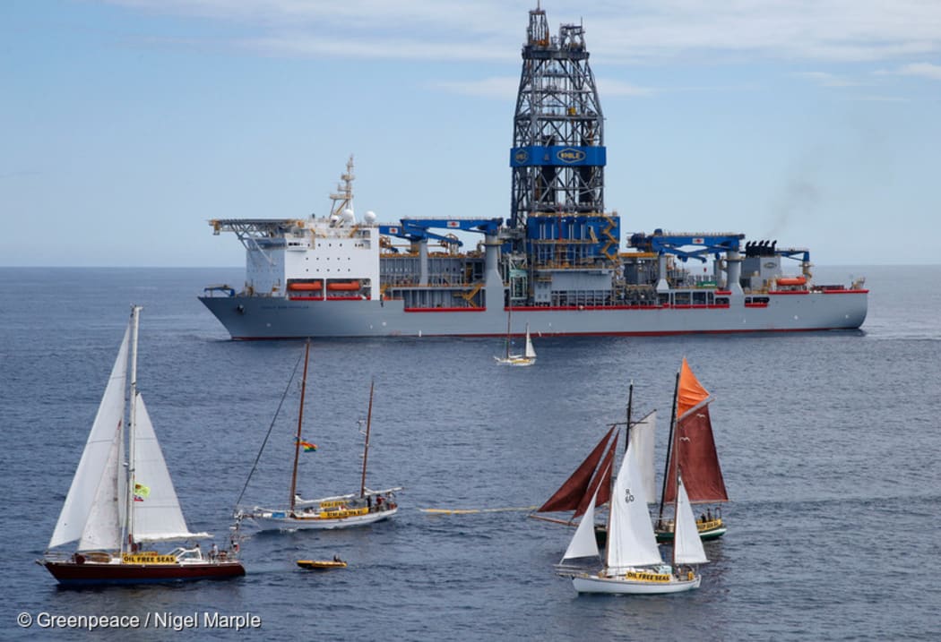 Greenpeace sponsored SV Vega confronts the Noble Bob Douglas drilling ship. Other yachts in the Oil Free Seas Flotilla say outside the 500 metre exclusion zone, from left, SV Tiama, SV Friendship, SV Shearwater II and SV Ratbag (brown sails).