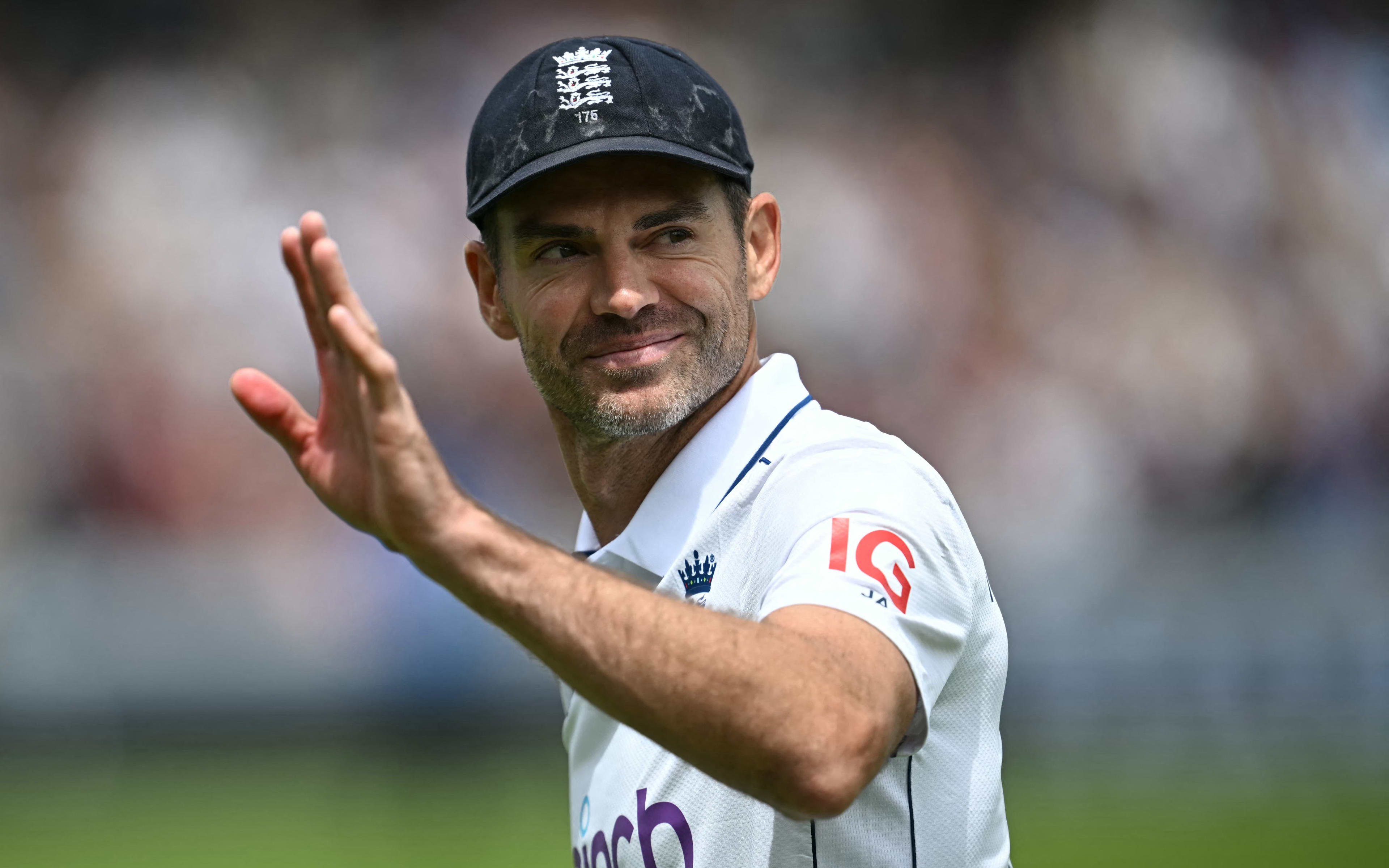 England's James Anderson waves to the crowd during a presentation ceremony after the conclusion of play on the third day of the first Test cricket match between England and West Indies at Lord's Cricket Ground in London on July 12, 2024, after England beat West Indies by an innings and 114 runs. James Anderson bowed out of international cricket on the winning side as England thrashed the West Indies by an innings and 114 runs on the third day of the first Test at Lord's. (Photo by Paul ELLIS / AFP)
