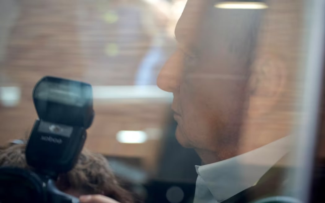 Veteran broadcaster Alan Jones arriving at Day Street Police Station in Sydney in the back of an unmarked police car on November 18, 2024. (ABC News: Ethan Rix)