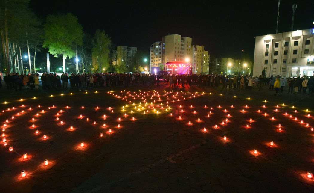 Candles are lit in the shape of a radiation hazard symbol on the 30th anniversary of the Chernobyl disaster.