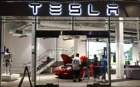 Tesla logo is seen at the showroom in Santa Monica, United States on November 12, 2023. (Photo by Jakub Porzycki/NurPhoto) (Photo by Jakub Porzycki / NurPhoto / NurPhoto via AFP)