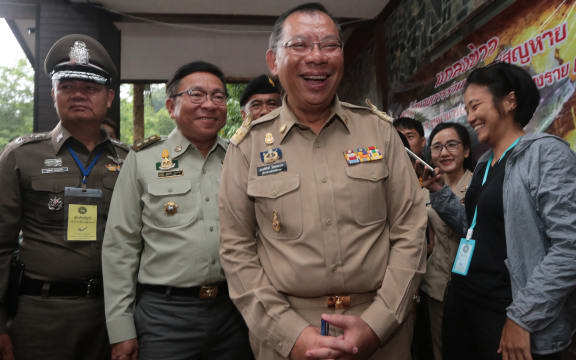 Chiang Rai governor Narongsak Osotthanakorn, centre, beams as he attends a press briefing on the mission to rescue the boys trapped in Tham Luang cave in Chiang Rai province, Thailand.