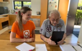 UC student Phoebe McCaughan providing one-on-one tech tutoring to a client