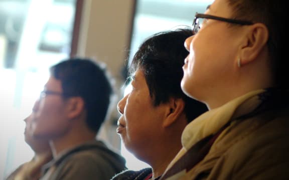 Potential buyers at a house auction in Manukau, Auckland.